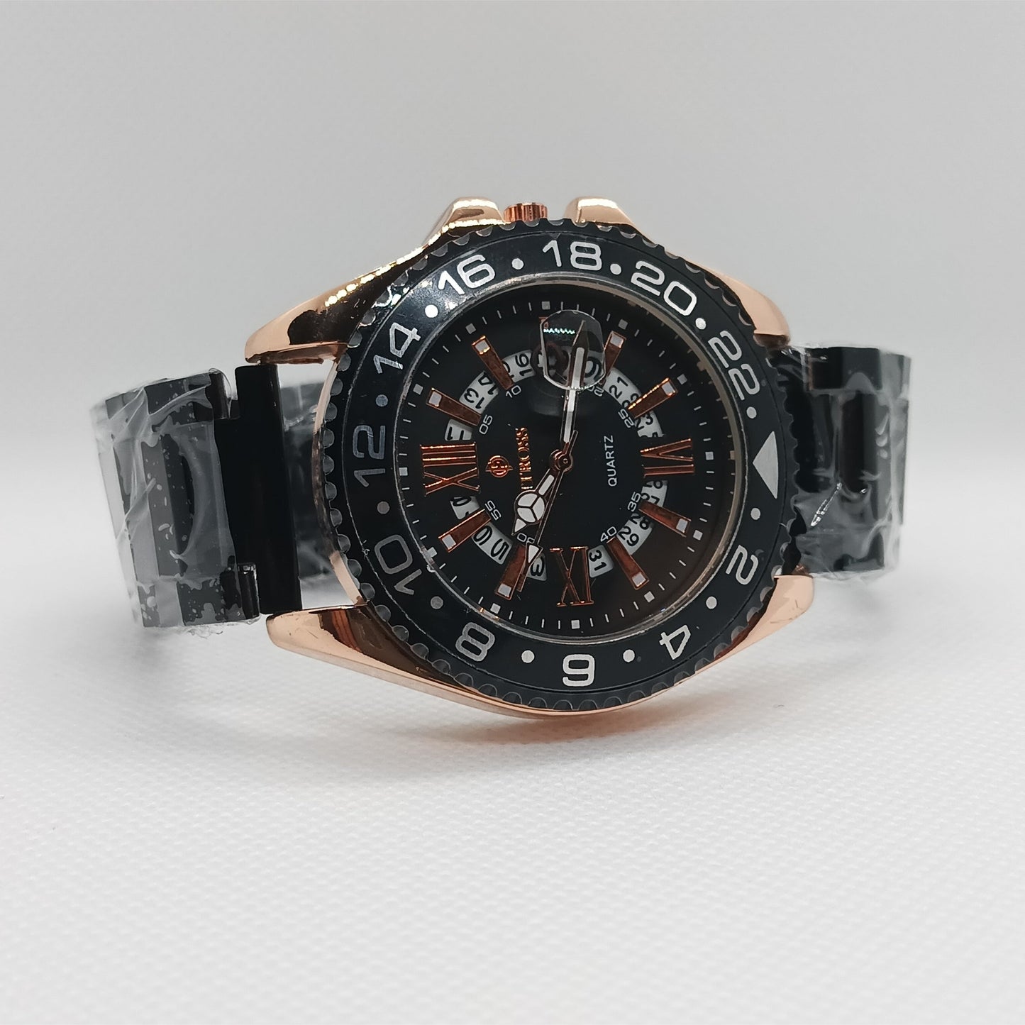 Luxury watch with black dial and rose gold case on a light gray background