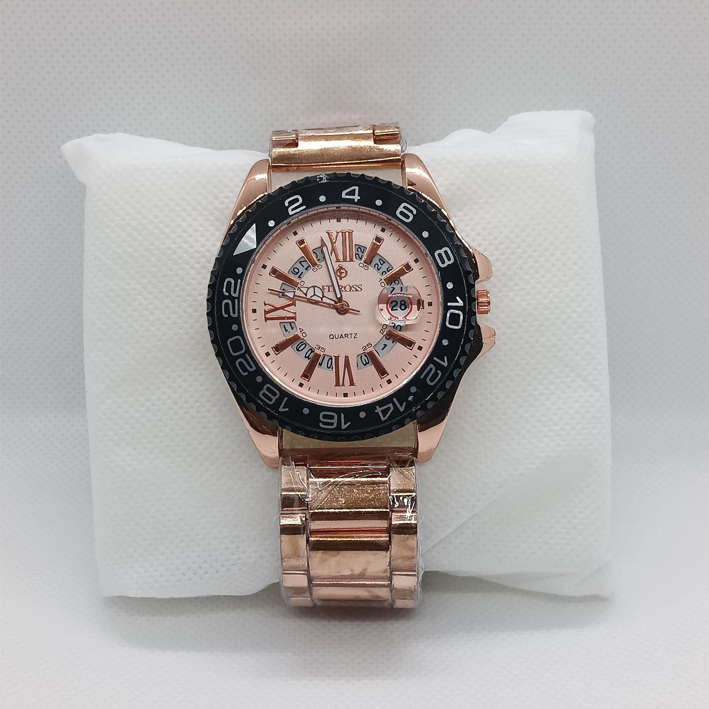 Rose gold watch with a detailed face on a white cushion
