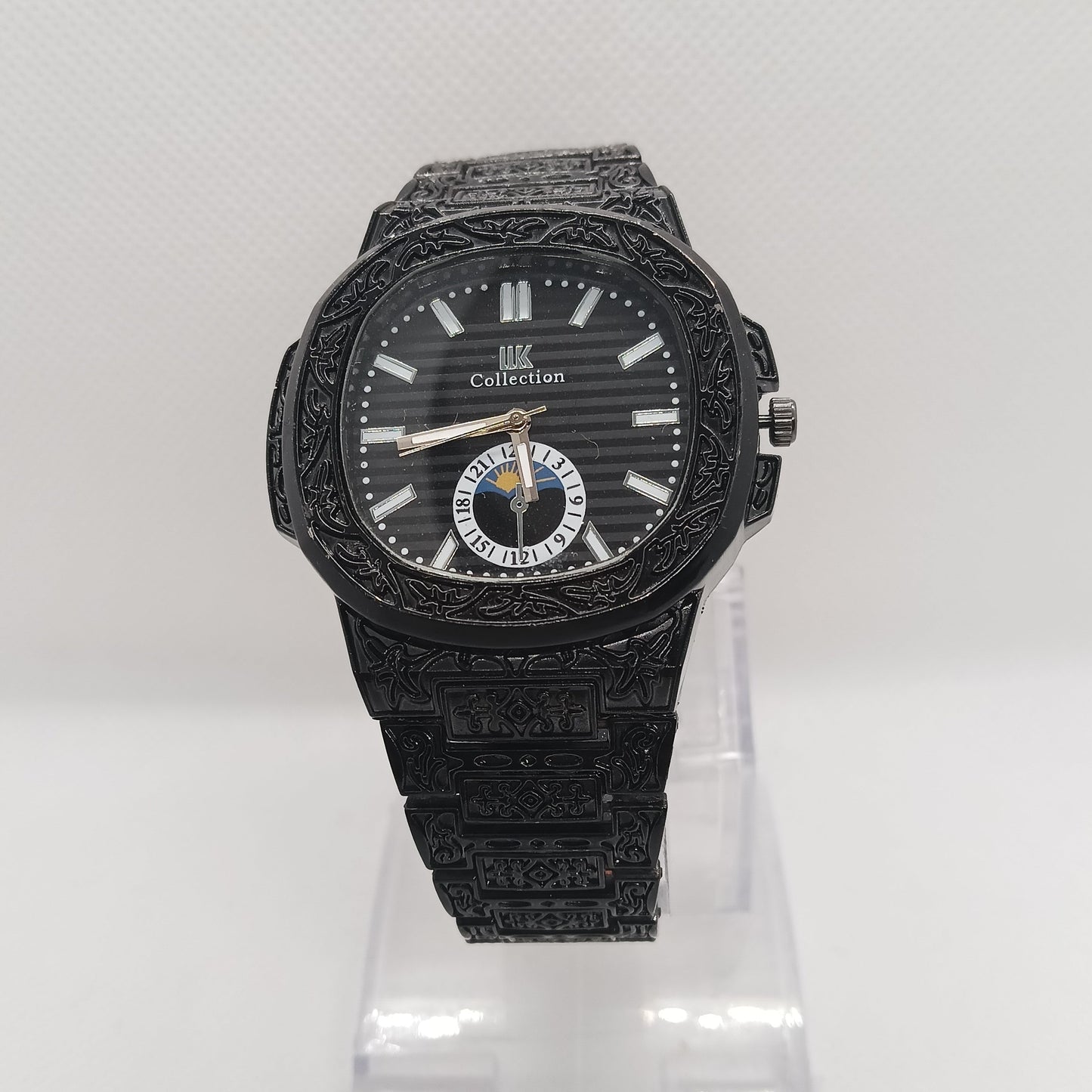 Black wristwatch with detailed design on a white background