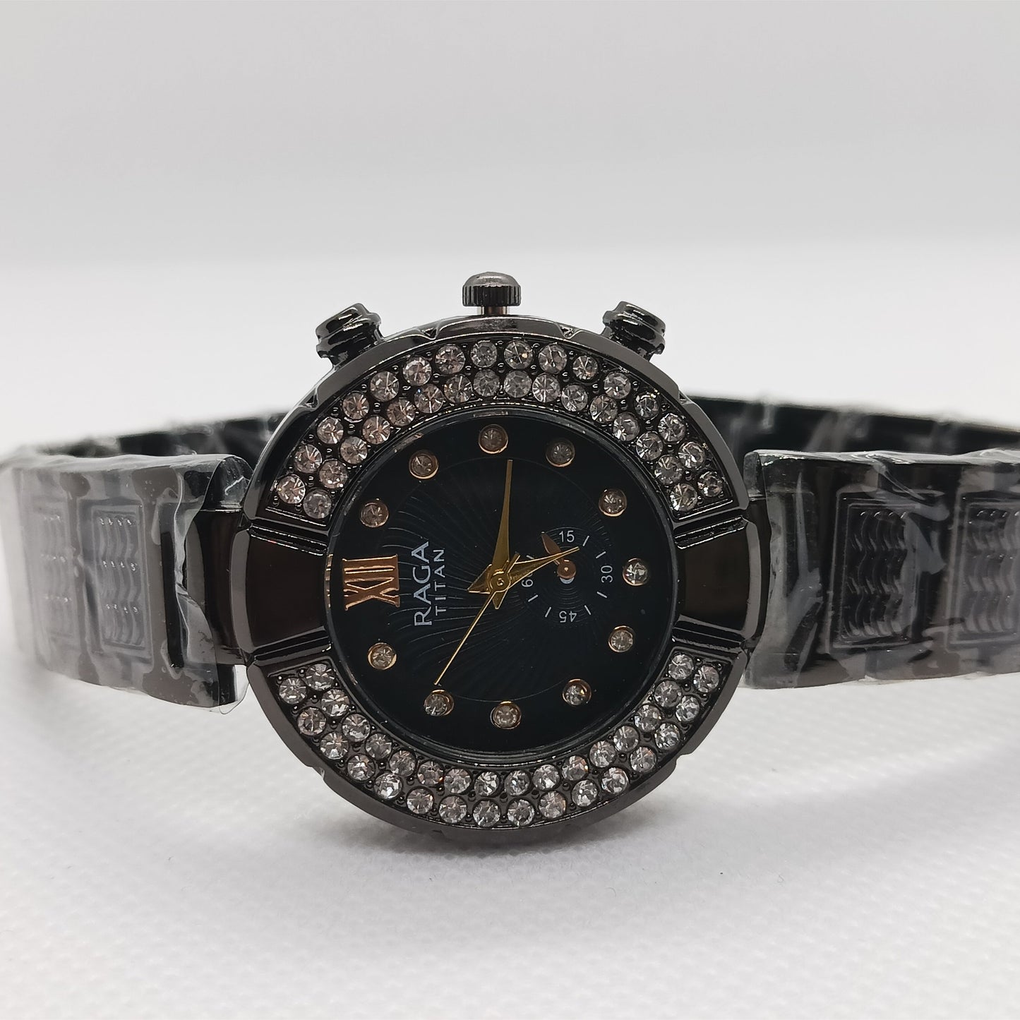 Wristwatch with decorative band and face on a white background