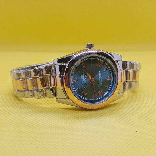 Silver watch with a black face on a yellow background