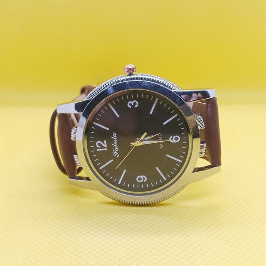 Watch with a brown strap and black dial on a yellow background