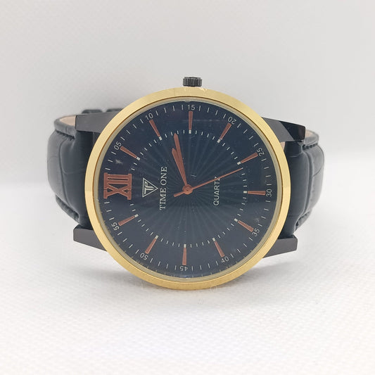 Watch with black strap and gold bezel on a white background