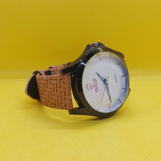 Wristwatch with brown strap on a yellow background