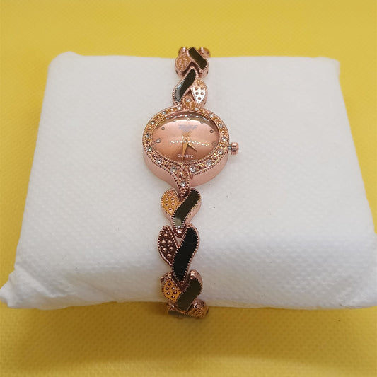 Rose gold bracelet on a white cushion against a yellow background