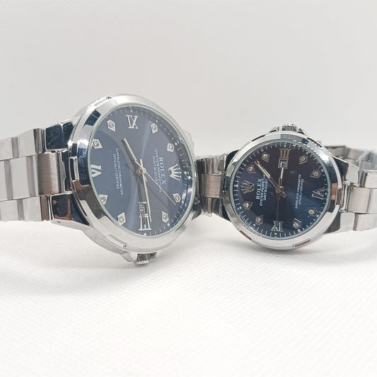 Two silver watches with blue faces on a white background