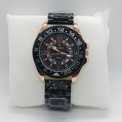 Luxury watch with black and rose gold design on a white cushion