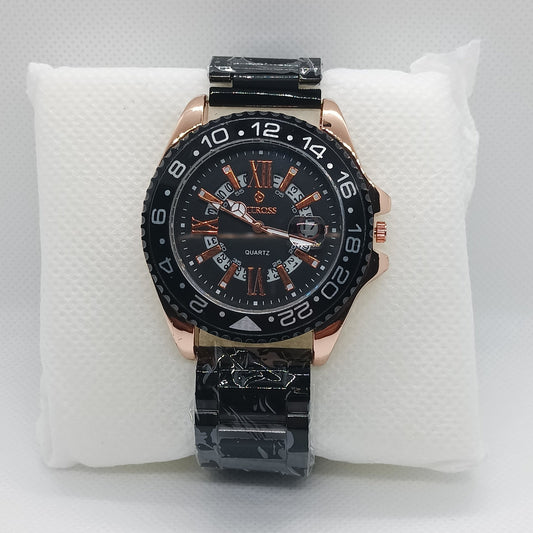 Luxury watch with black and rose gold design on a white cushion