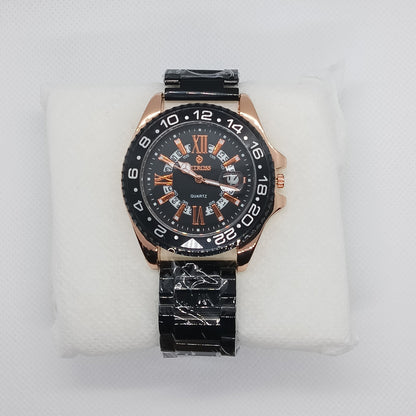Wristwatch with black and rose gold design on a white cushion