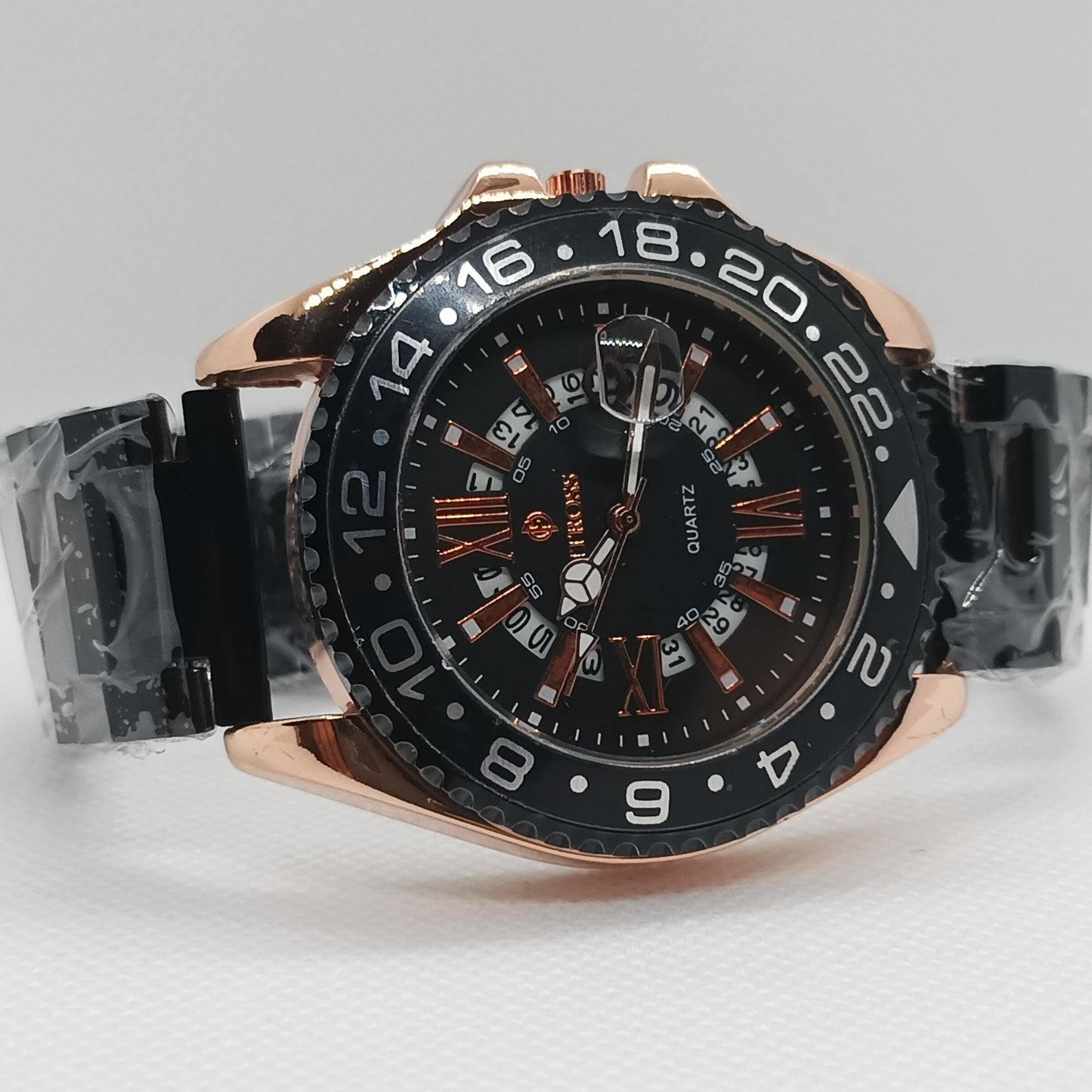 Luxury watch with black dial and rose gold case on a light gray background