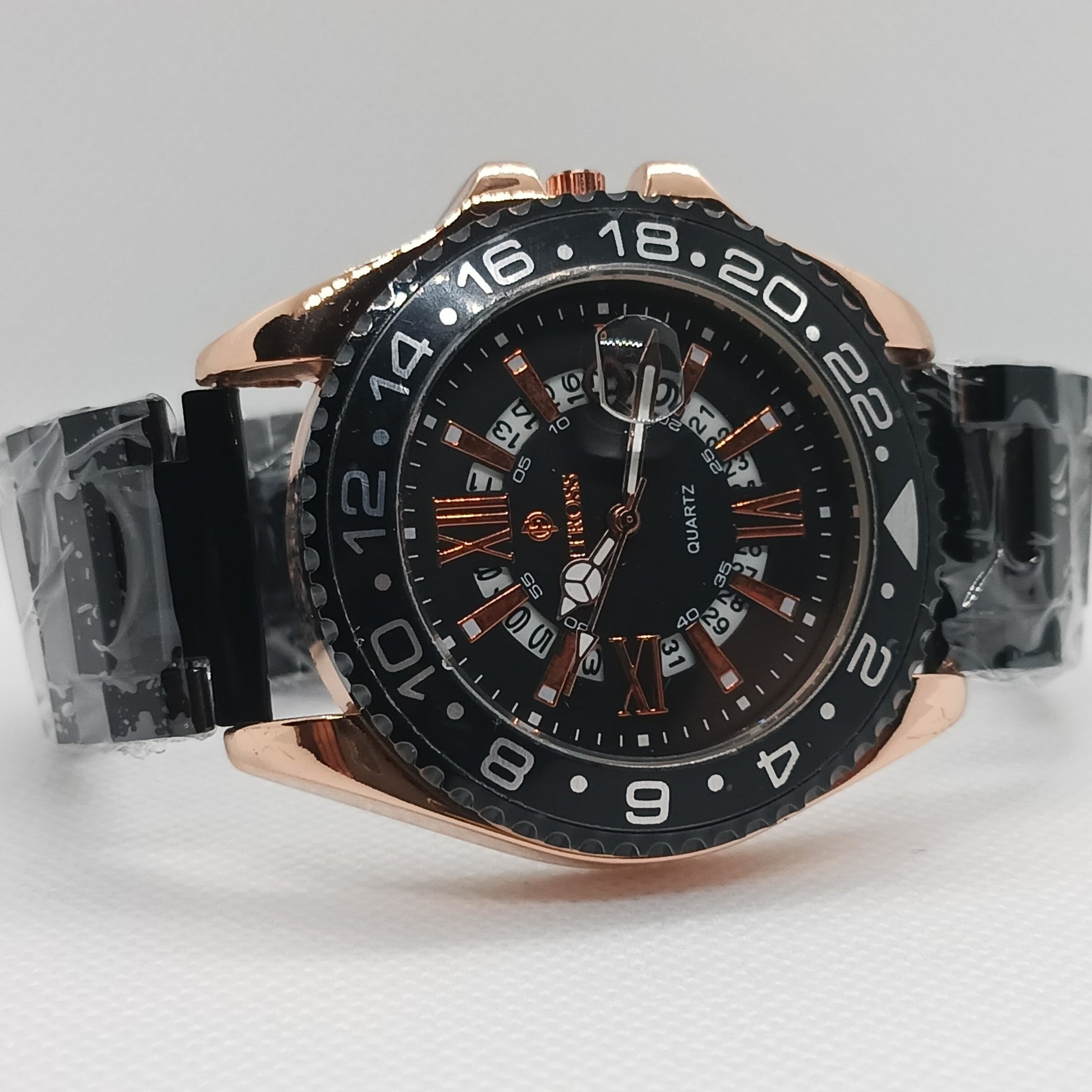 Luxury watch with black dial and rose gold case on a light gray background