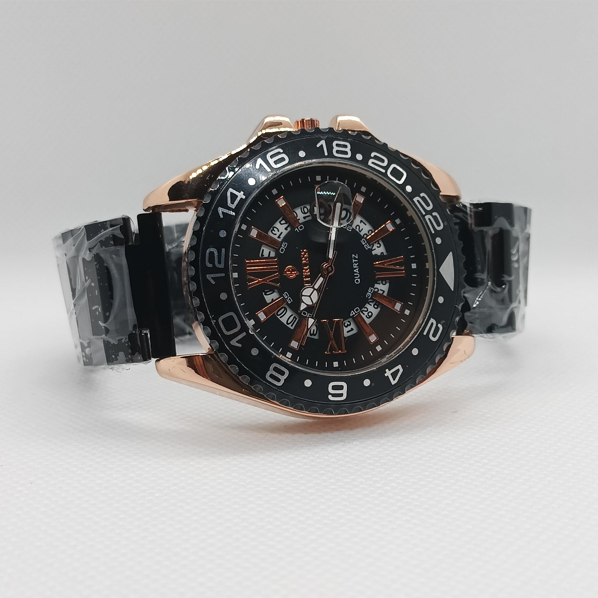 Luxury watch with black dial and rose gold case on a light gray background