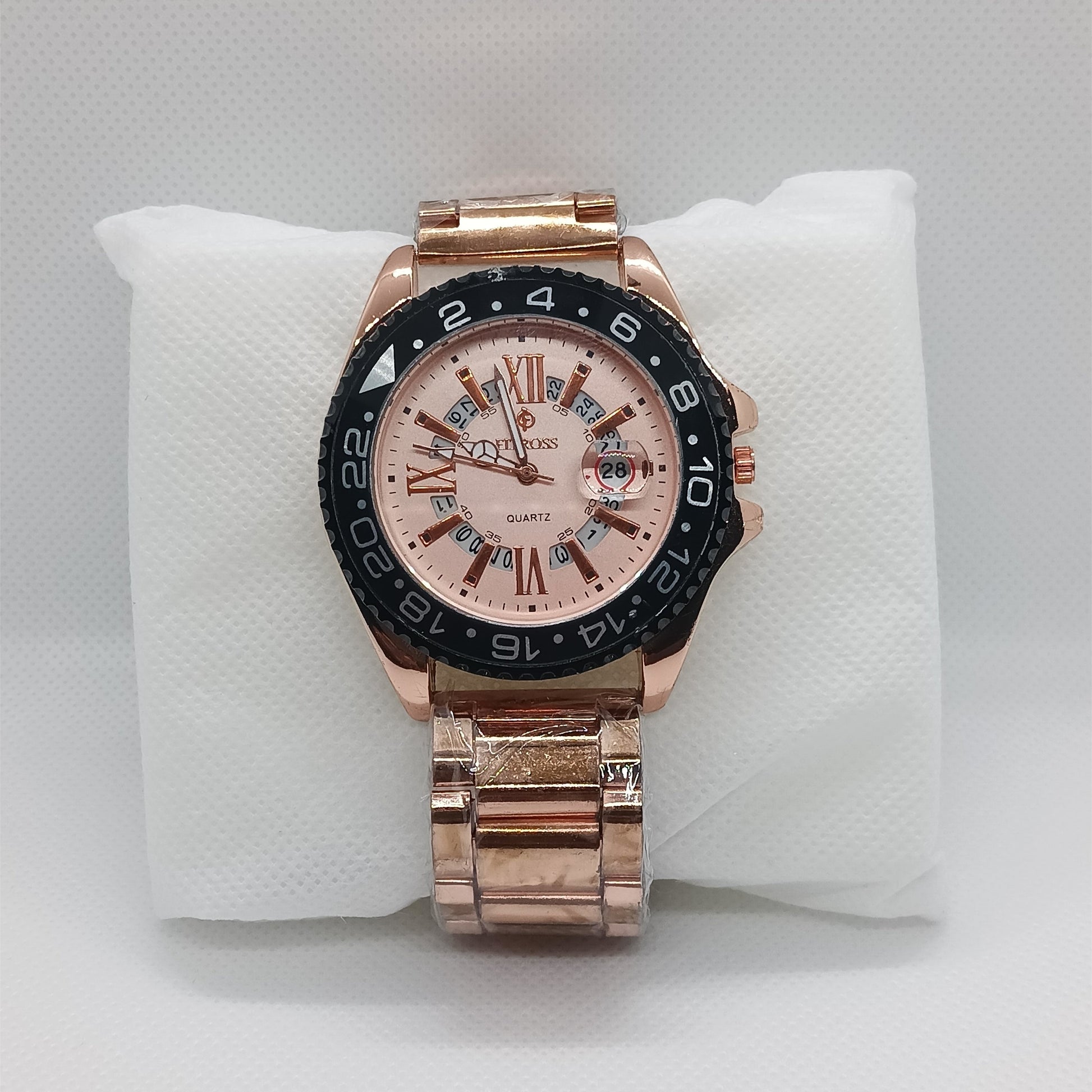 Rose gold watch with a detailed face on a white cushion