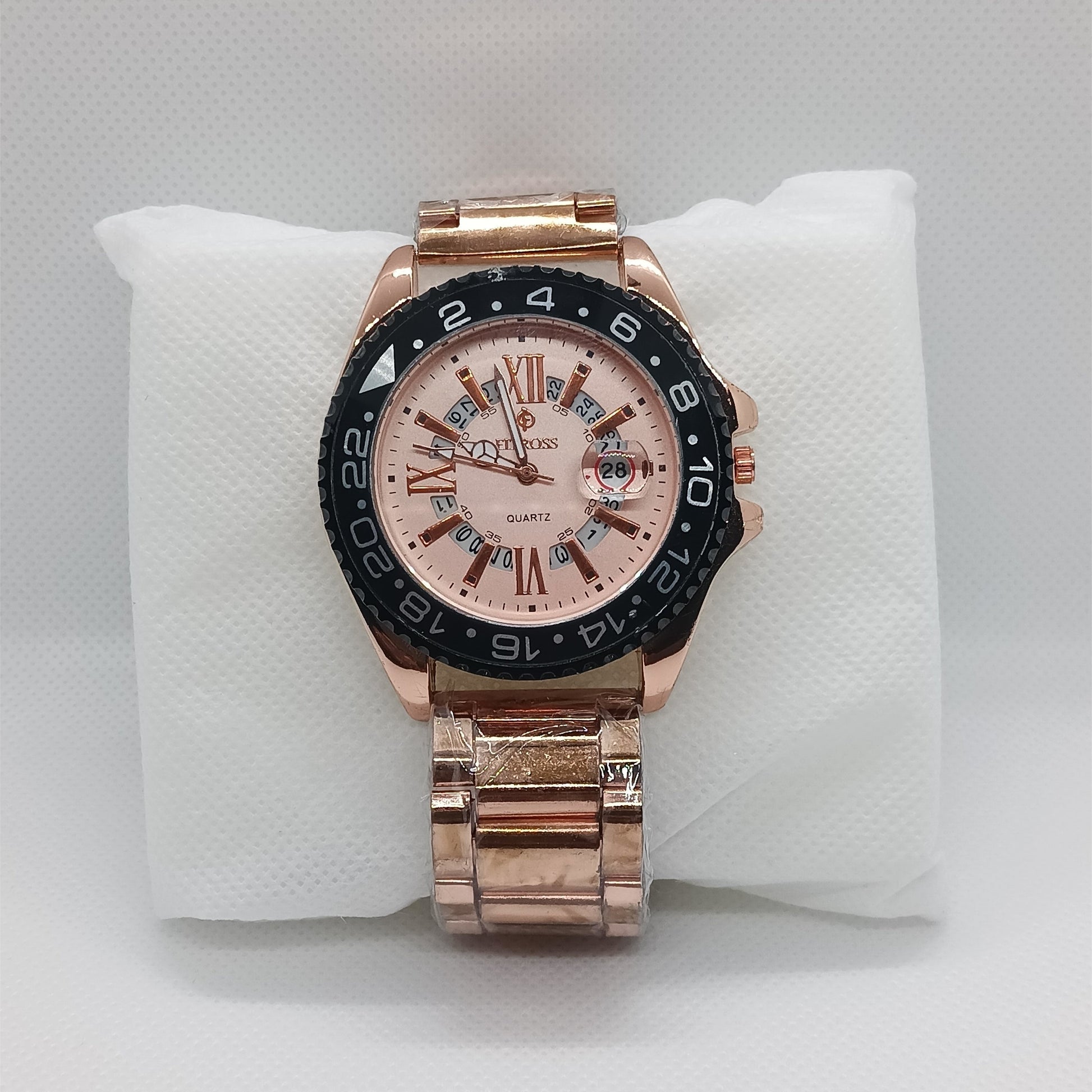 Rose gold watch with a detailed face on a white cushion