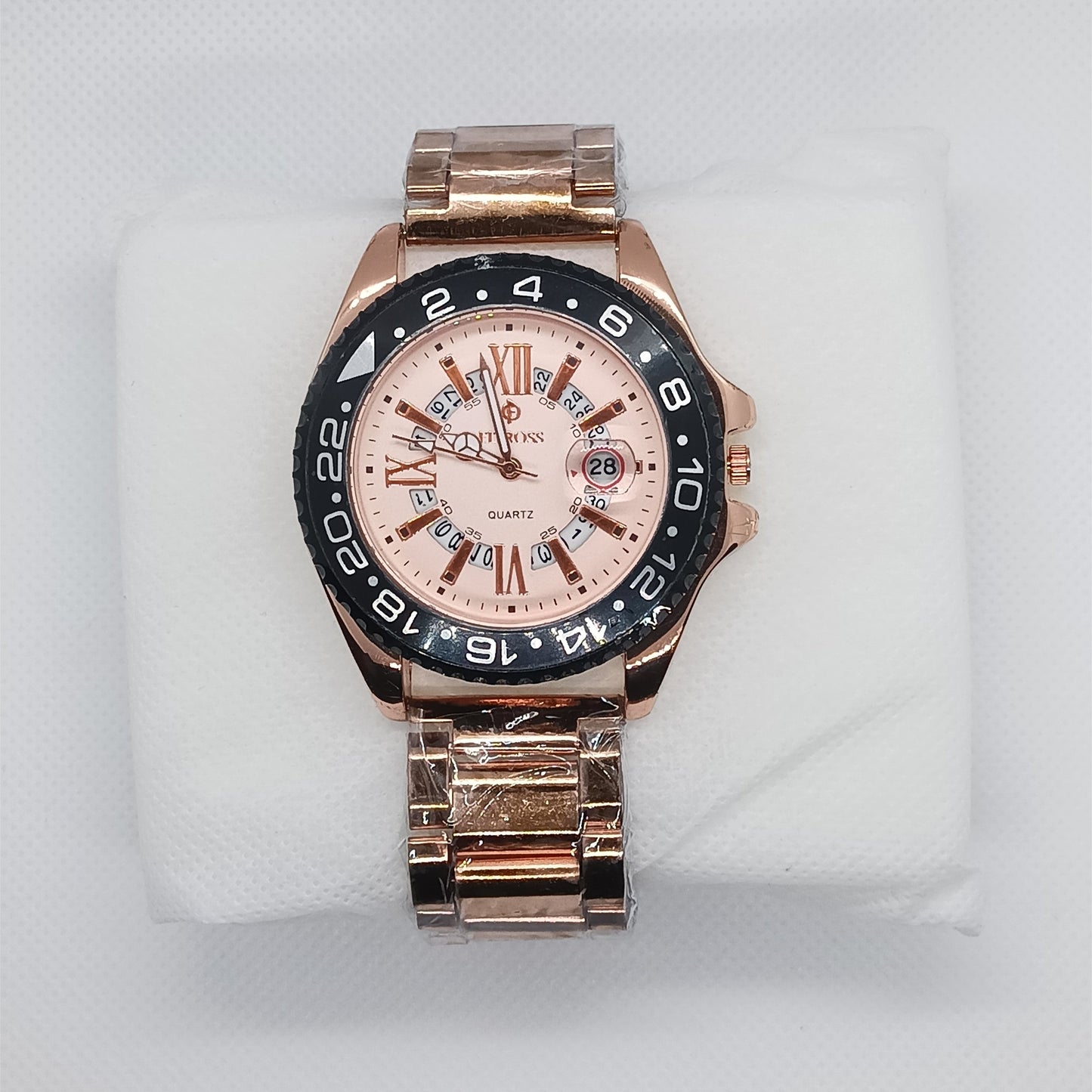 Rose gold watch with a detailed face on a white cushion