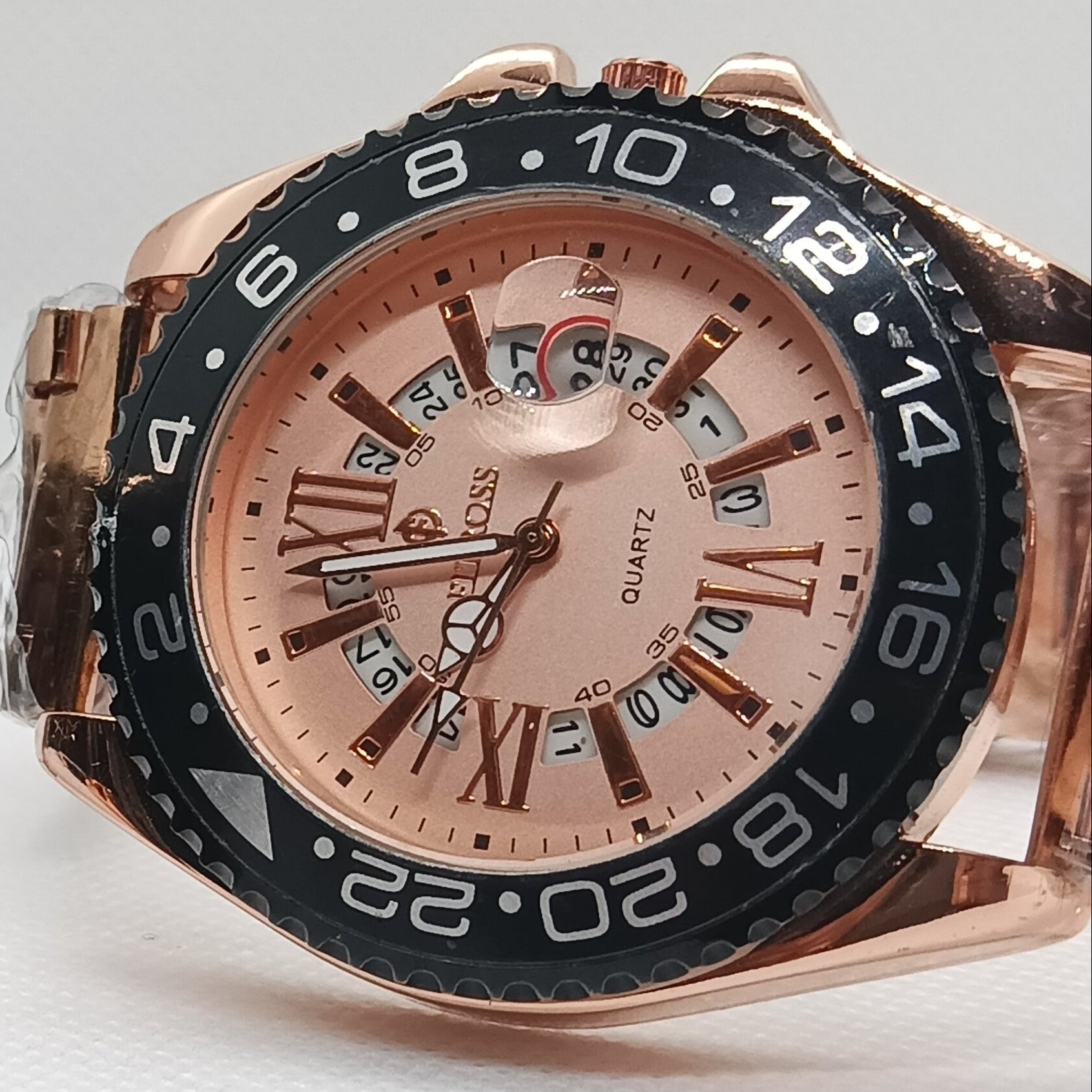 Two rose gold watches with black and rose gold faces on a light gray background