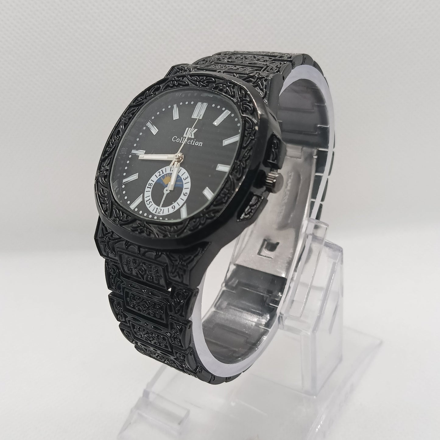 Black textured watch with clear plastic packaging on a white background
