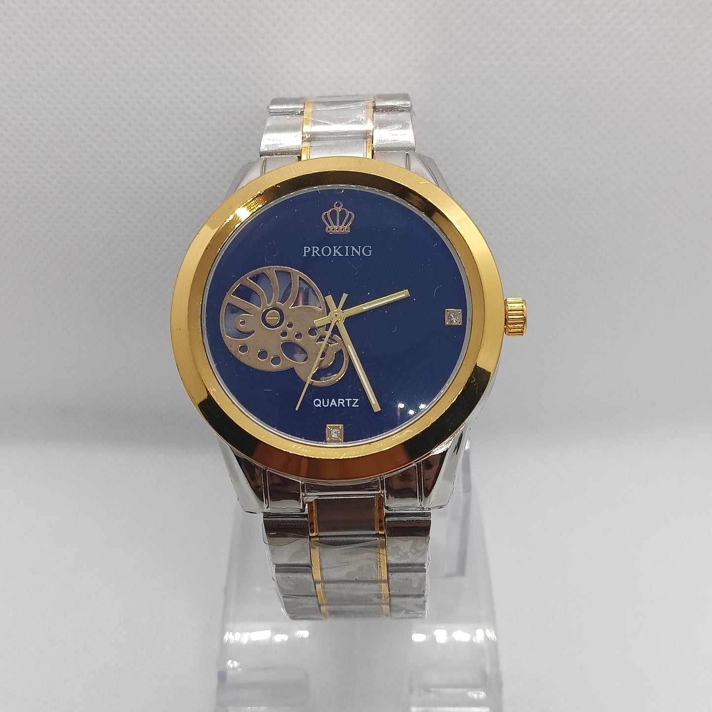 Luxury watch with blue face and gold accents on a white background