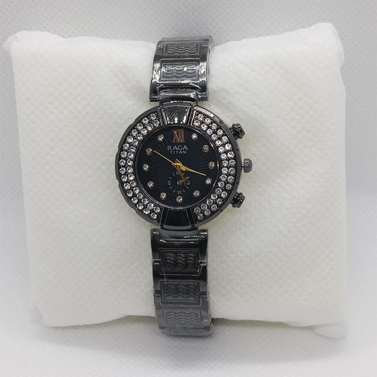 Black watch with a black face on a white cushion