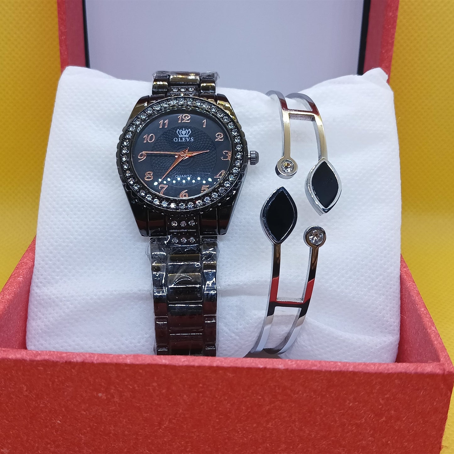Watch and bracelet set in a red box on a yellow background