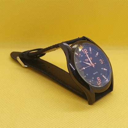 Black car clock with blue face on a yellow background