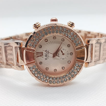 Rose gold watch with gemstone accents on a white background