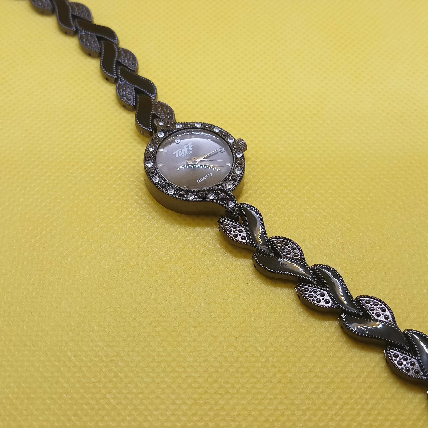Bracelet with braided design on a yellow background