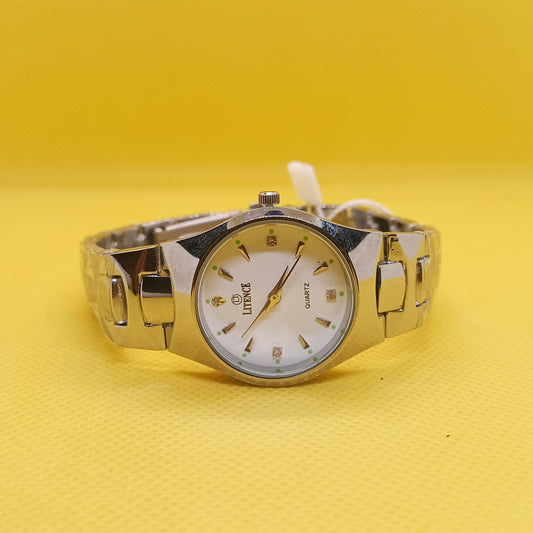 Gold wristwatch on a yellow background