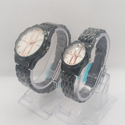 Two black wristwatches with white faces on a light gray background