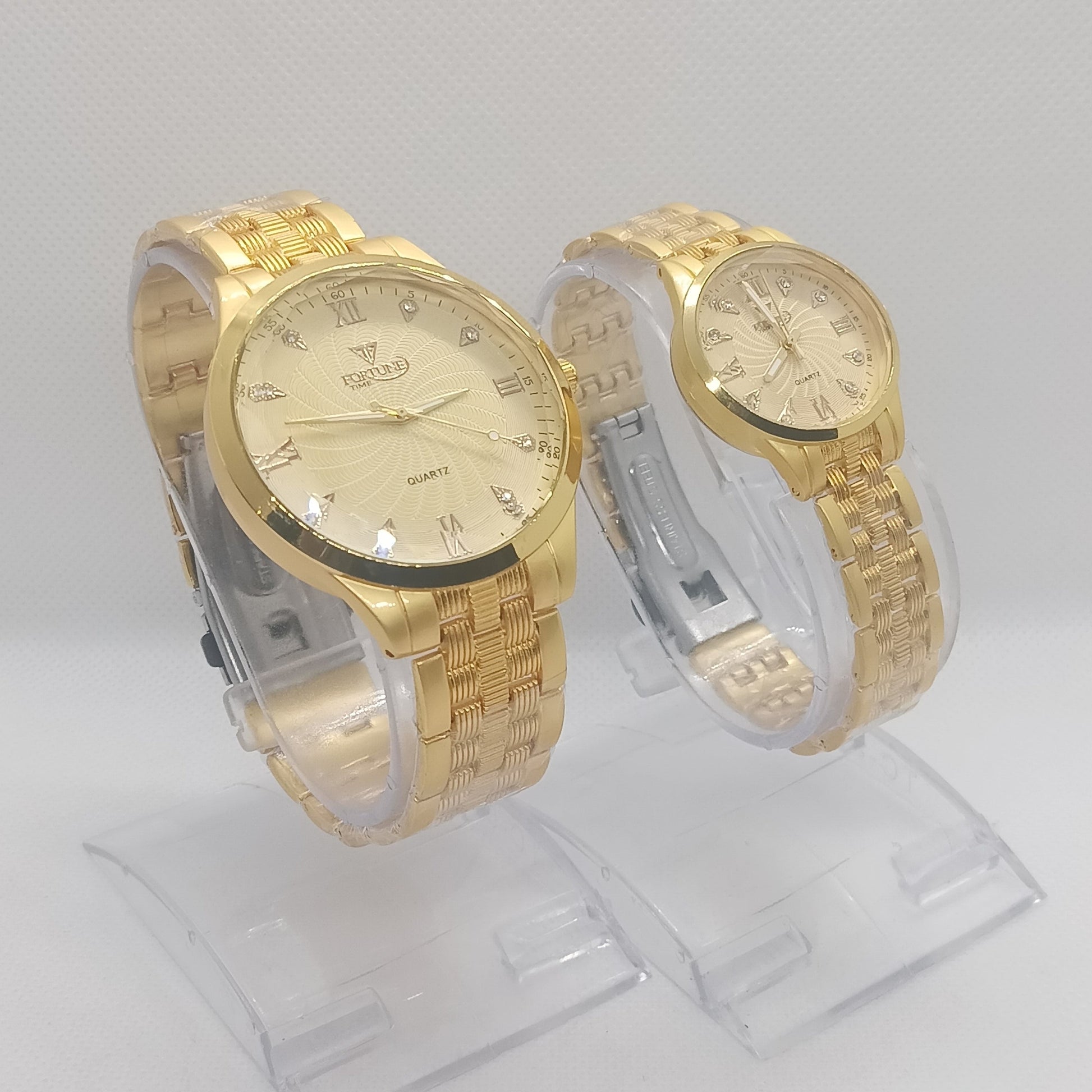 Two gold wristwatches on a white background