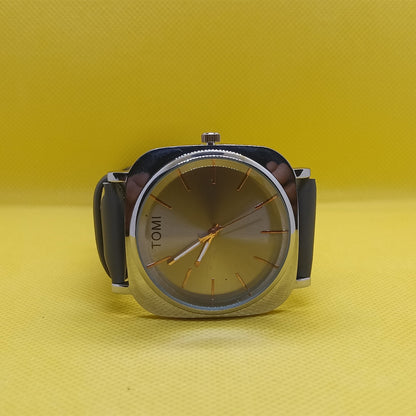 Watch with a black strap and silver case on a yellow background