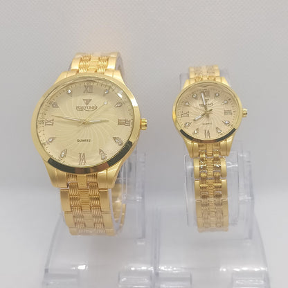 Two gold watches on a clear plastic stand against a white background