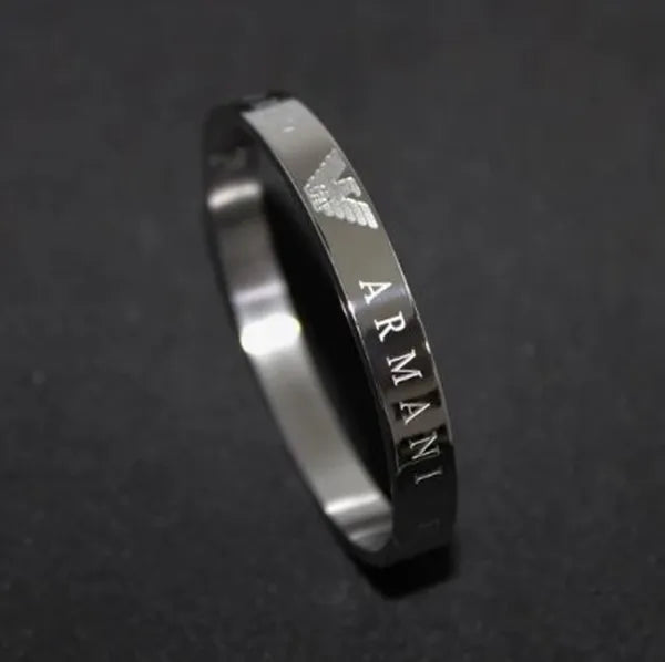 Silver Armani ring on a dark background