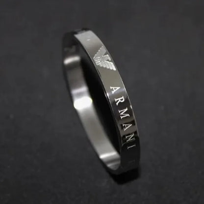 Silver Armani ring on a dark background