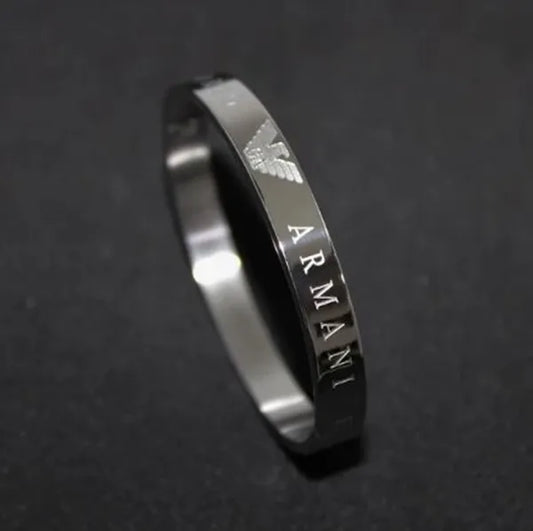 Silver Armani ring on a dark background