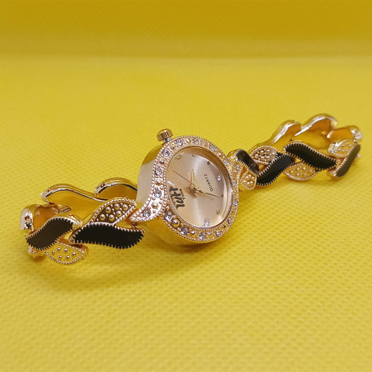 Gold watch with decorative band on a yellow background