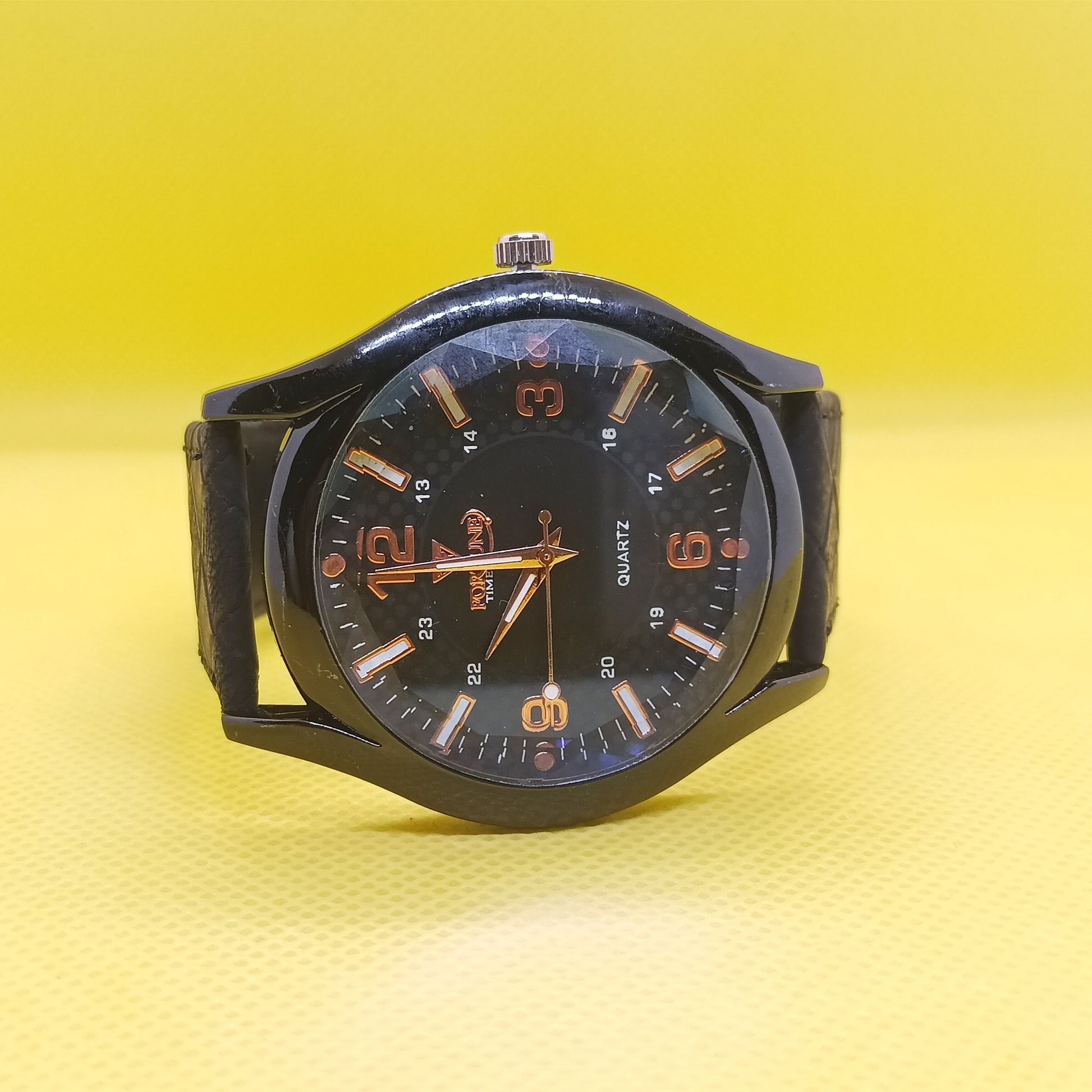 Black wristwatch with a yellow gradient background