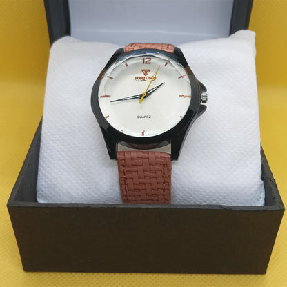 Watch with brown strap in a black box on a yellow background