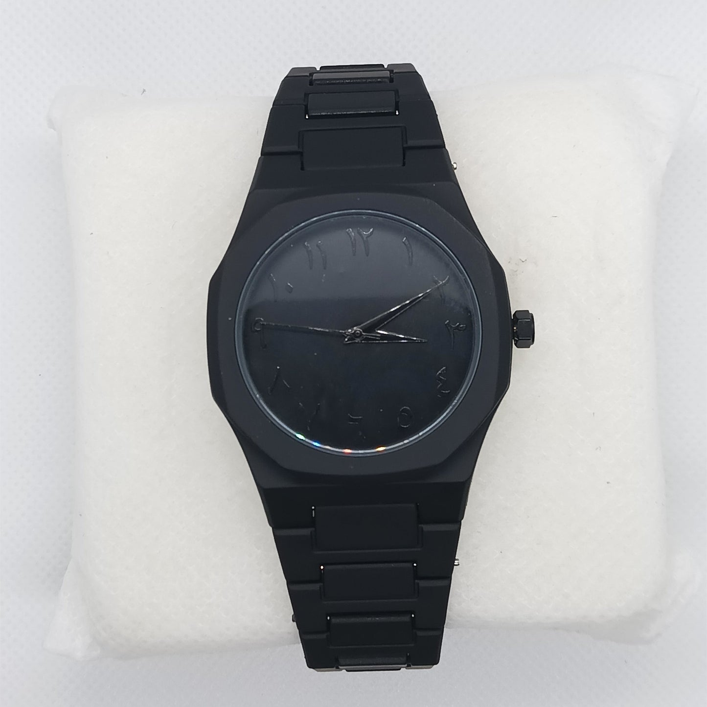 Black watch on a white cushion