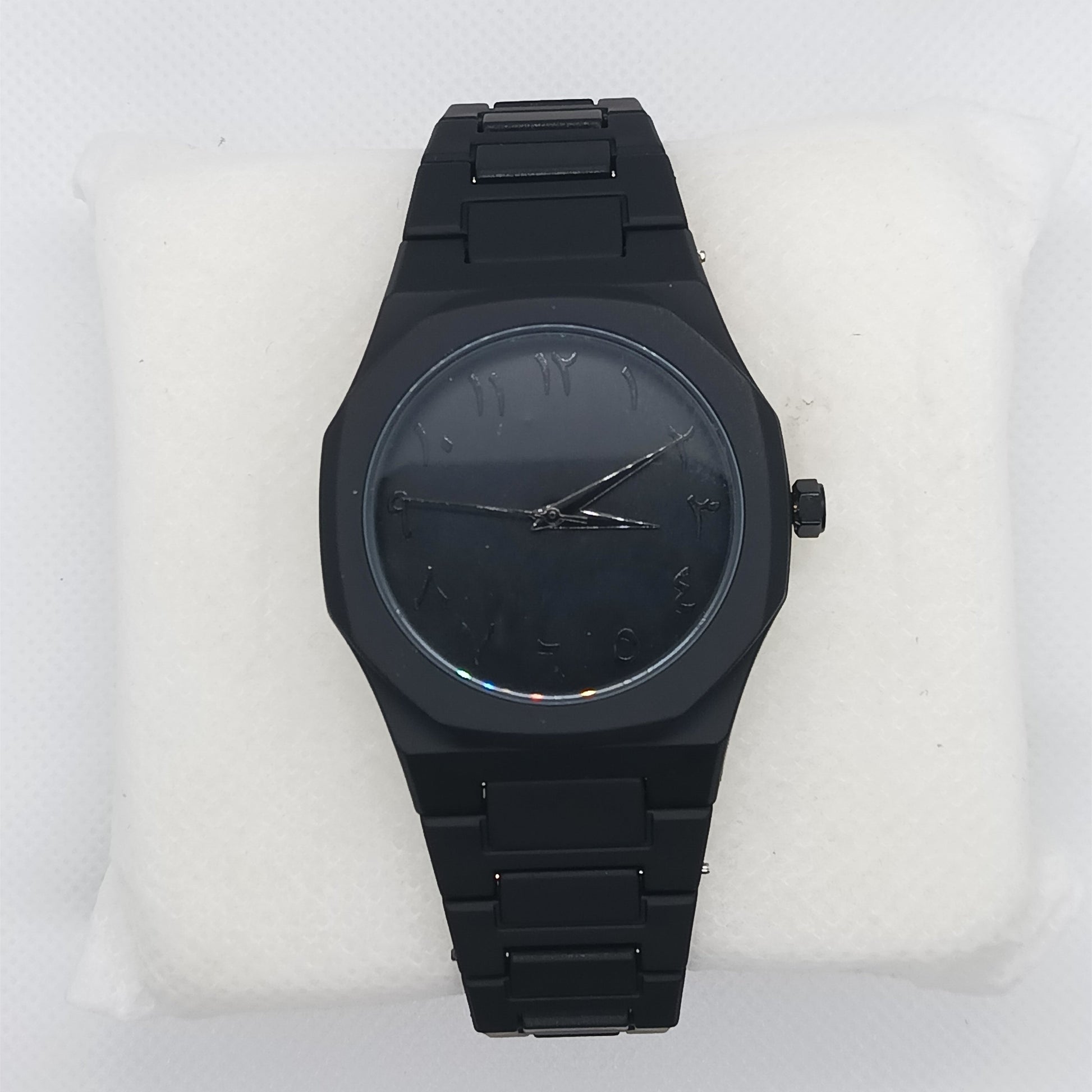 Black watch on a white cushion