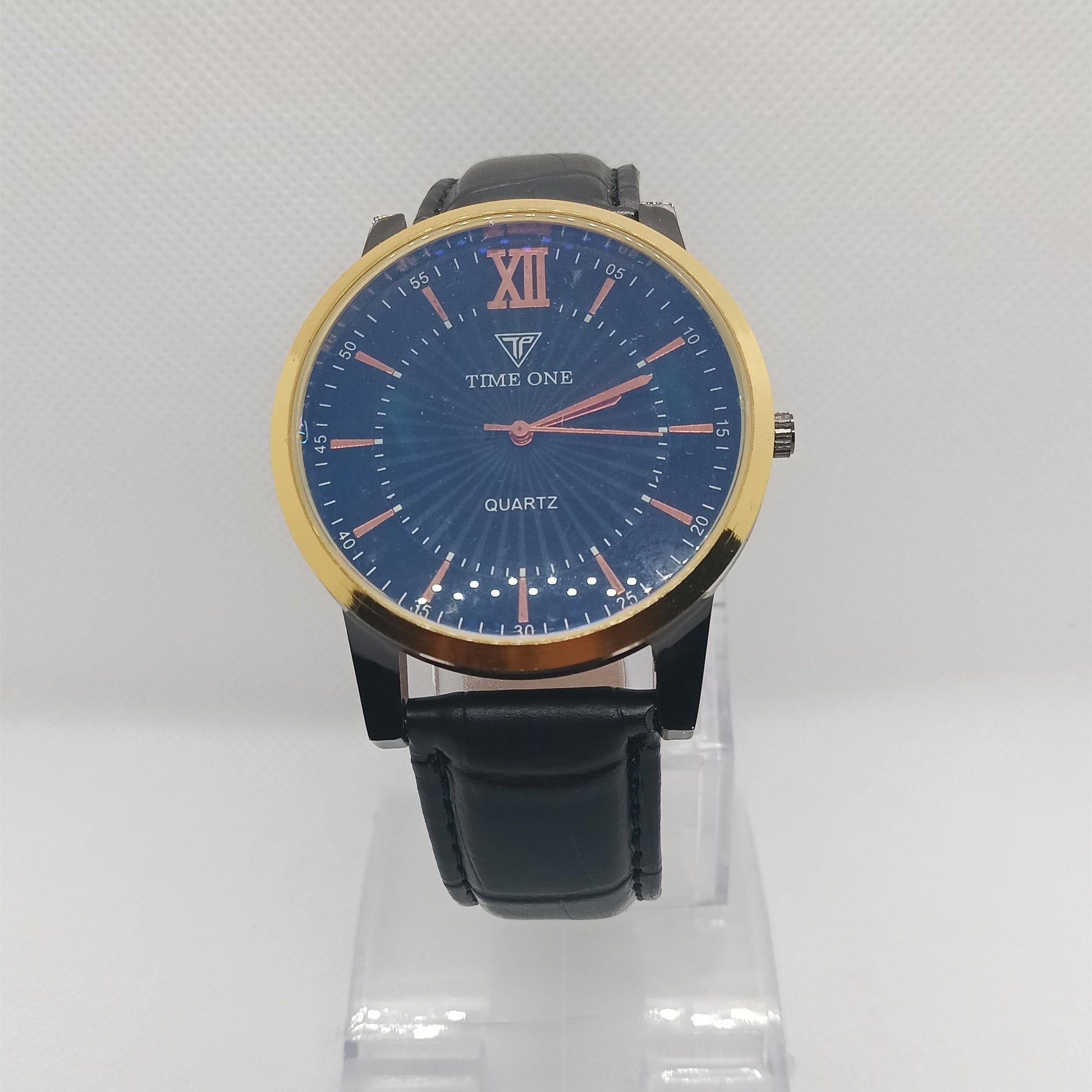 Wristwatch with blue dial and black strap on a white background