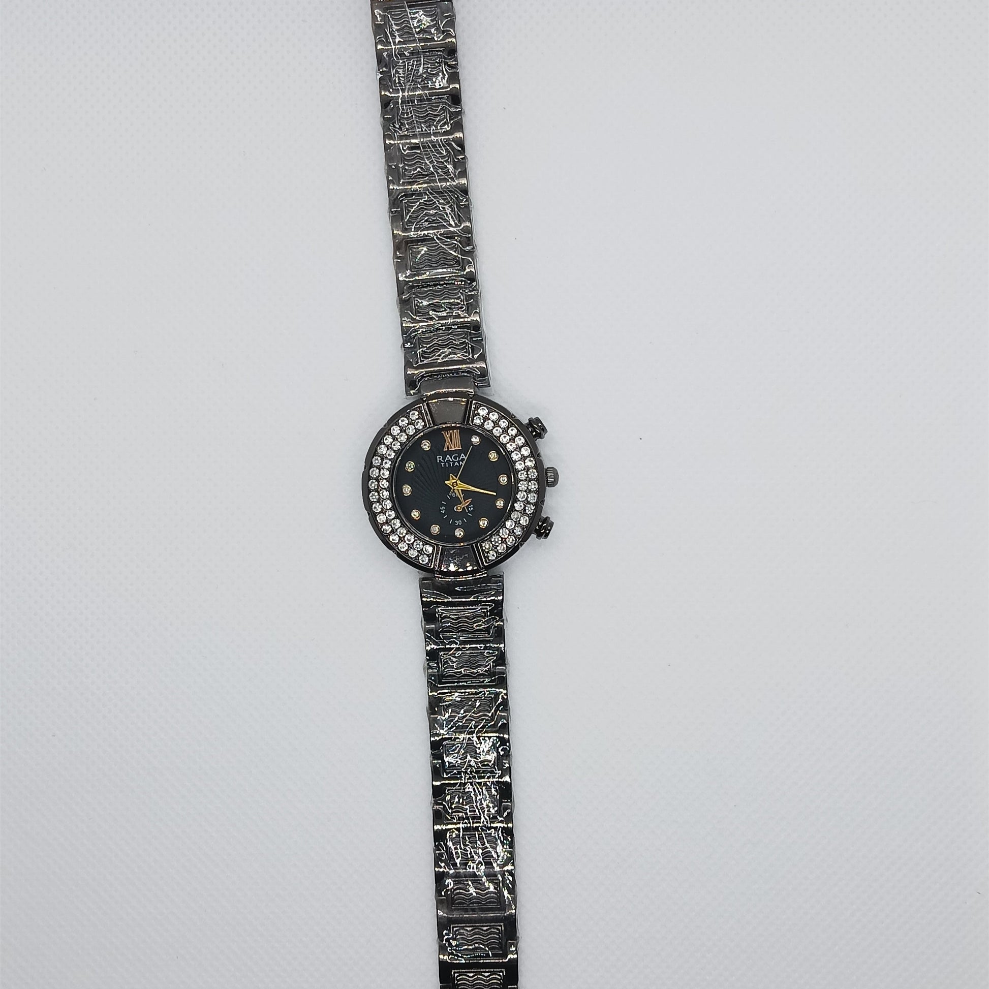 Wristwatch with intricate design on a light gray background