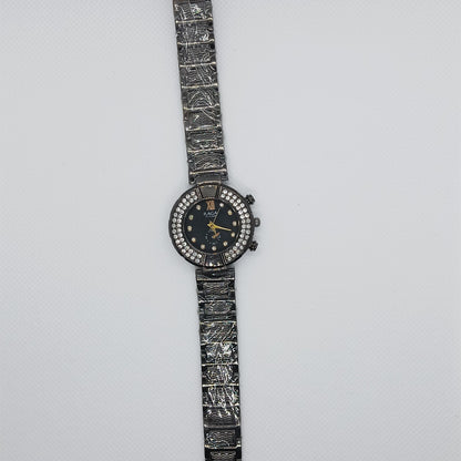 Wristwatch with intricate design on a light gray background
