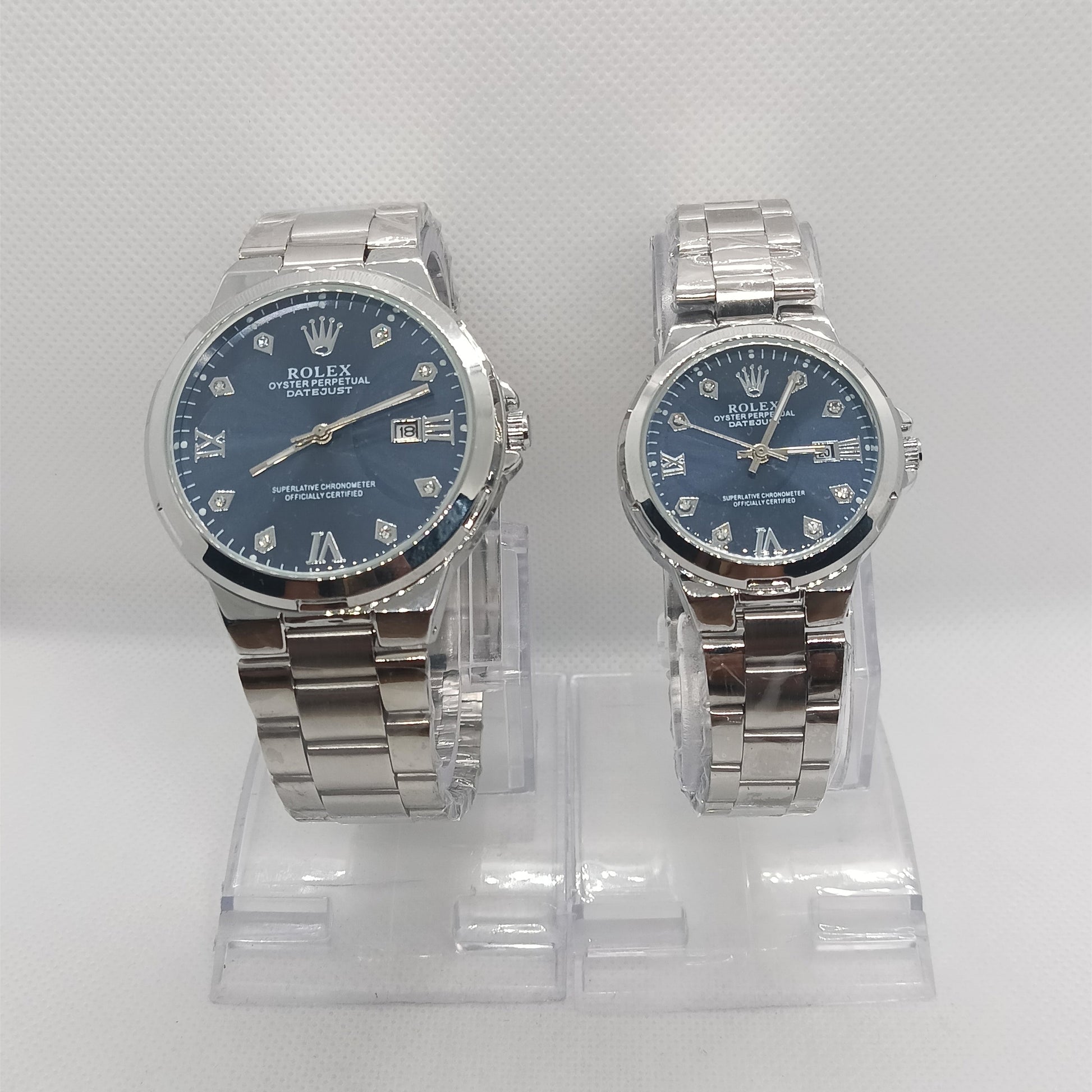 Two silver watches with blue faces on a white background