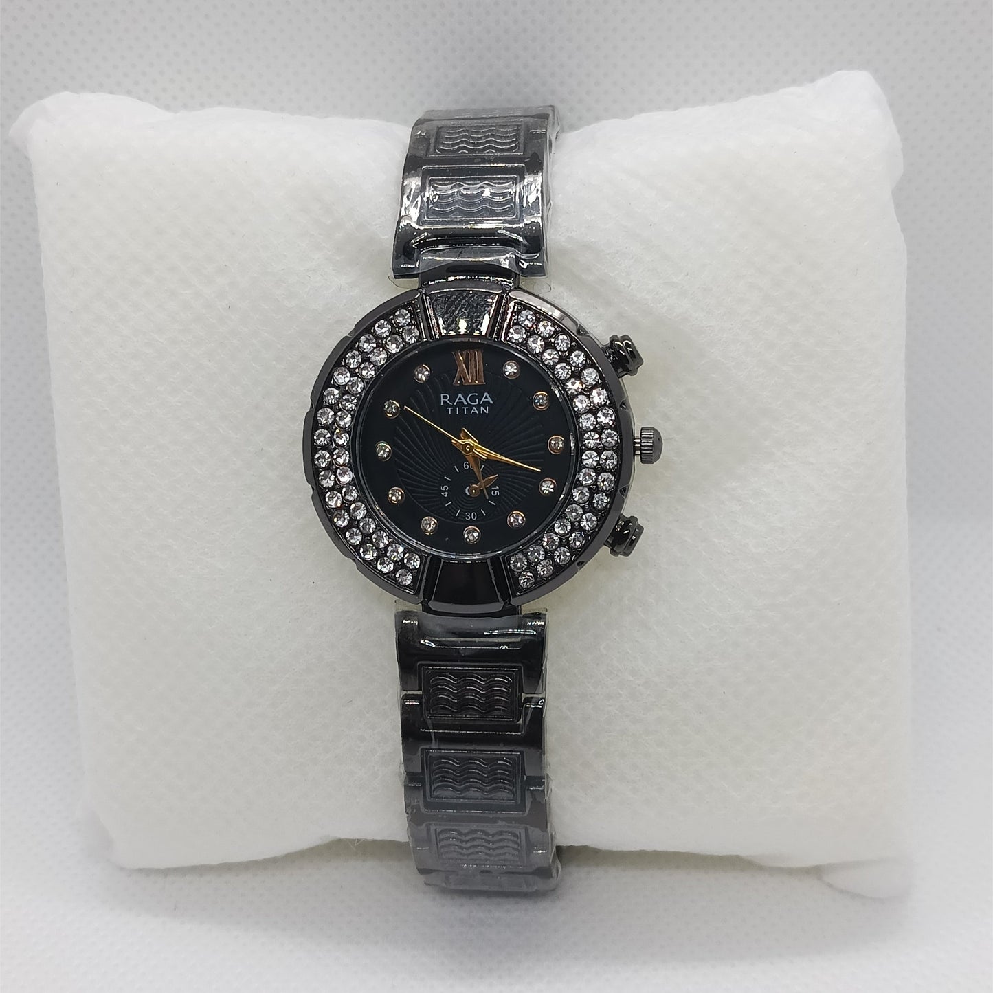 Black watch with black face on a white cushion