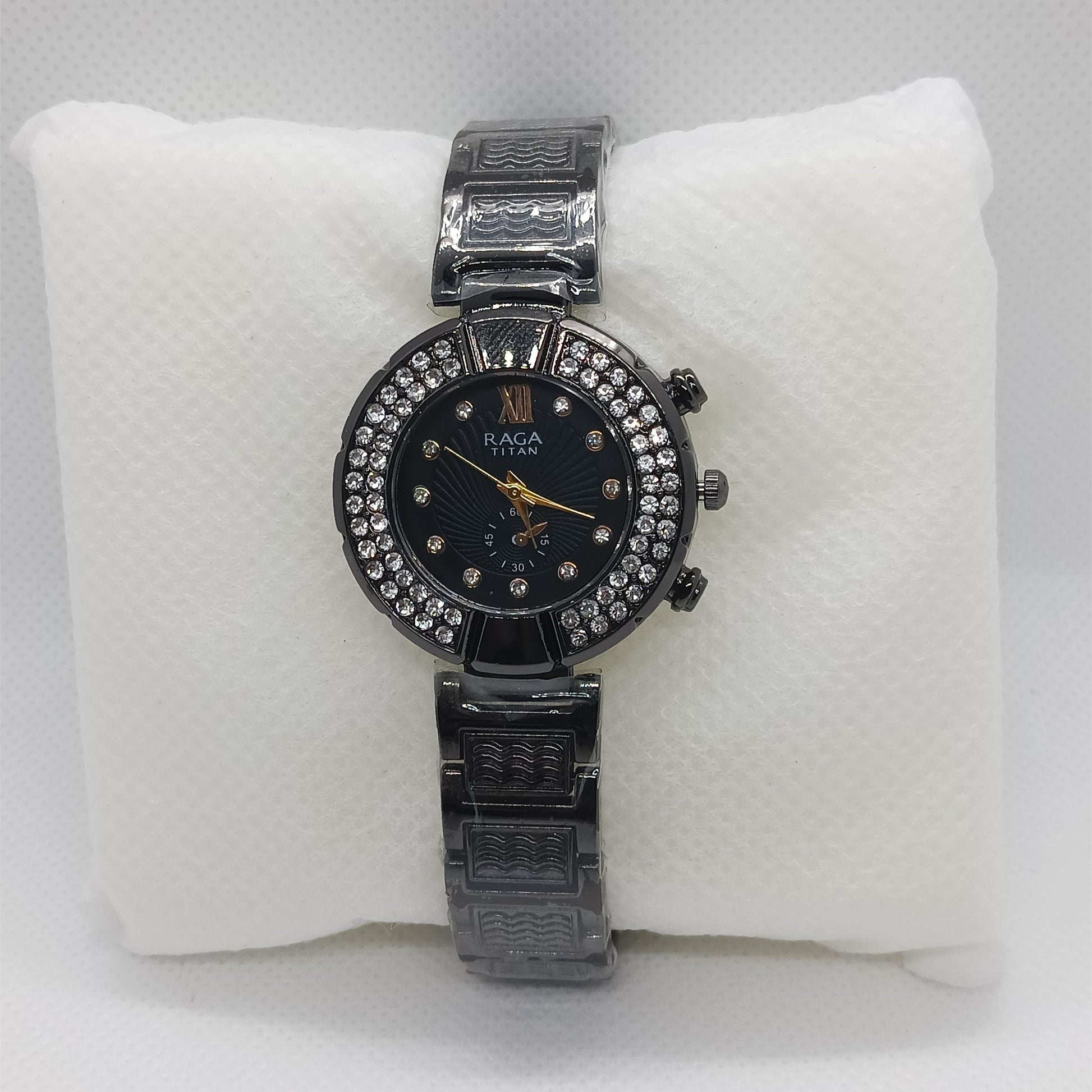 Black watch with black face on a white cushion