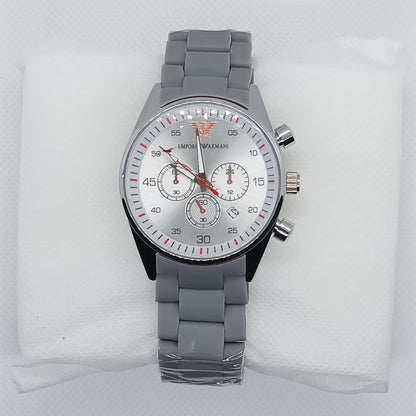 Gray wristwatch with a detailed face on a white cushion