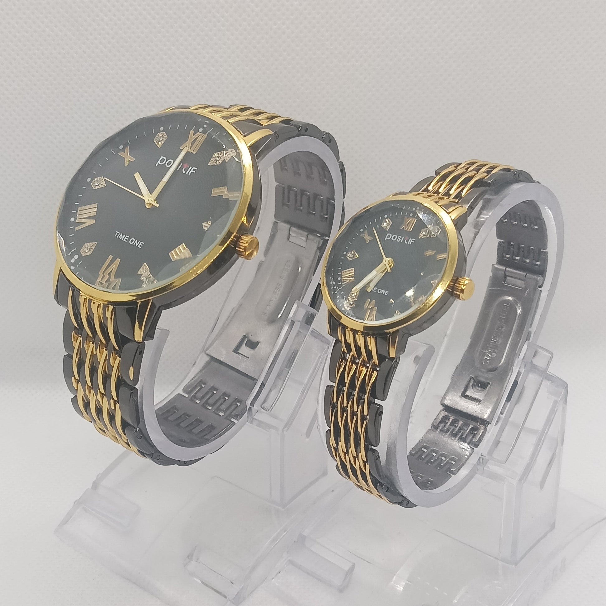 Two watches with gold and black straps on a white background