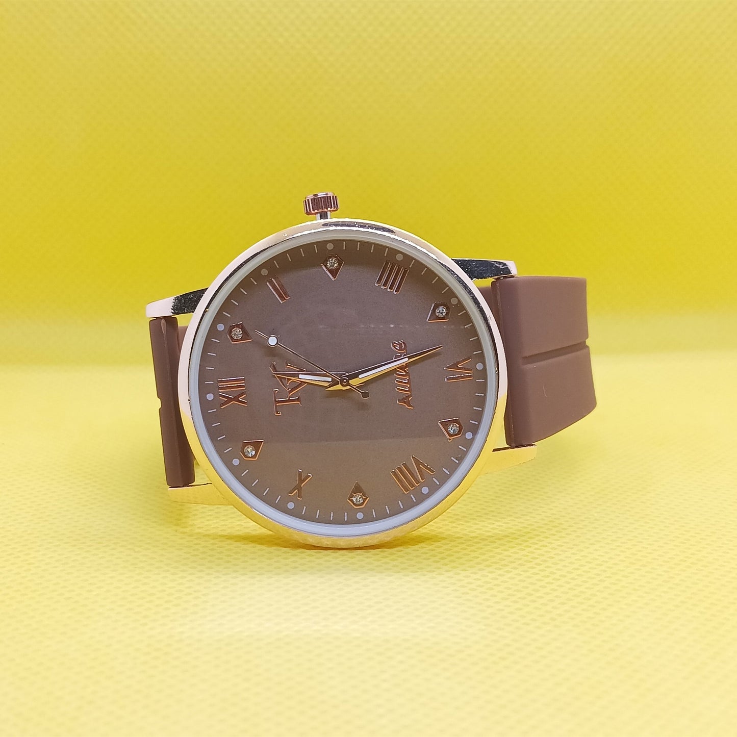 Wristwatch with brown strap and face on a yellow background