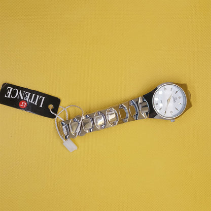 Silver wristwatch with a visible brand tag on a yellow background